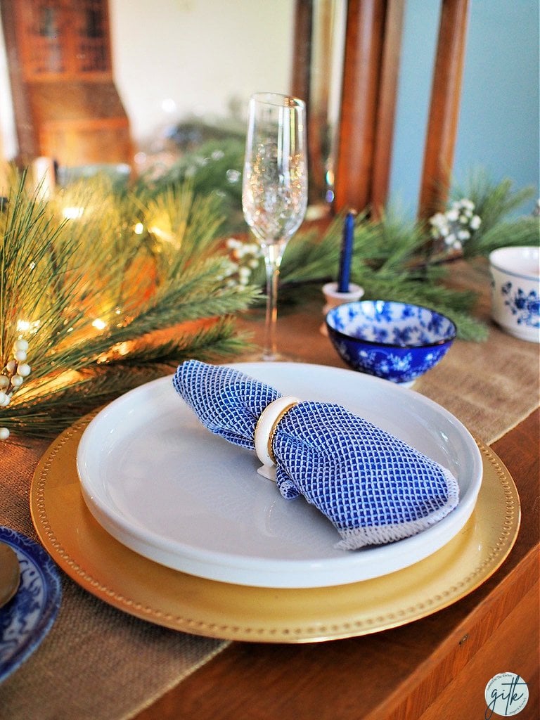 Christmas dinner table decorations in blues and gold following a