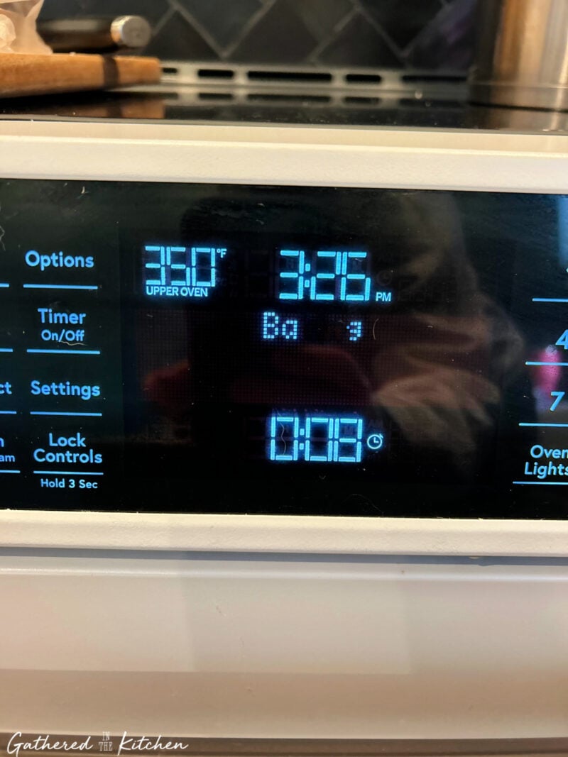 Close-up of an oven control panel showing 350°F baking temperature and an 8-minute timer, the ideal baking time for chewy pumpkin chocolate chip cookies. | Gathered In The Kitchen 