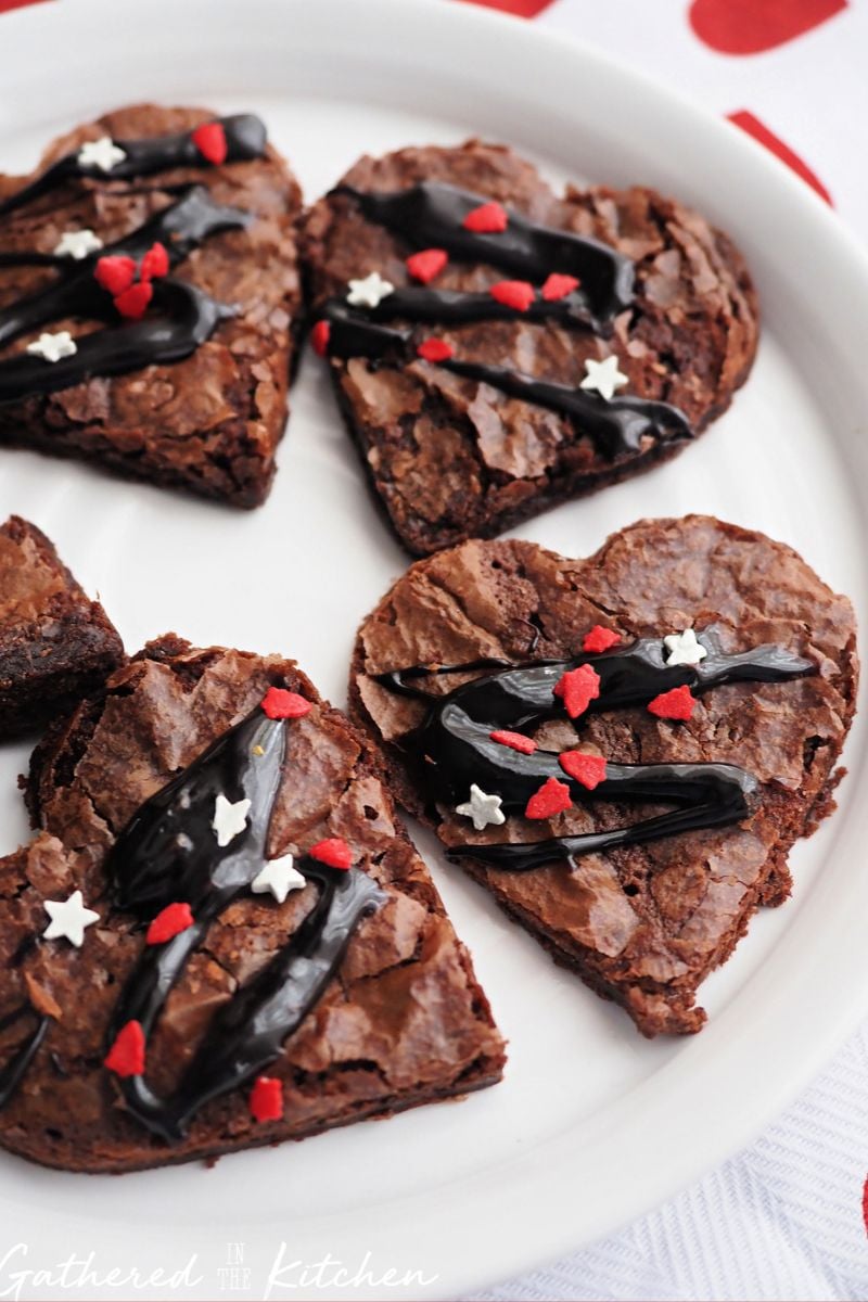 Heart Shaped Brownies drizzled with chocolate fudge and red and white sprinkles for Valentine's Day recipe | Gathered In The Kitchen