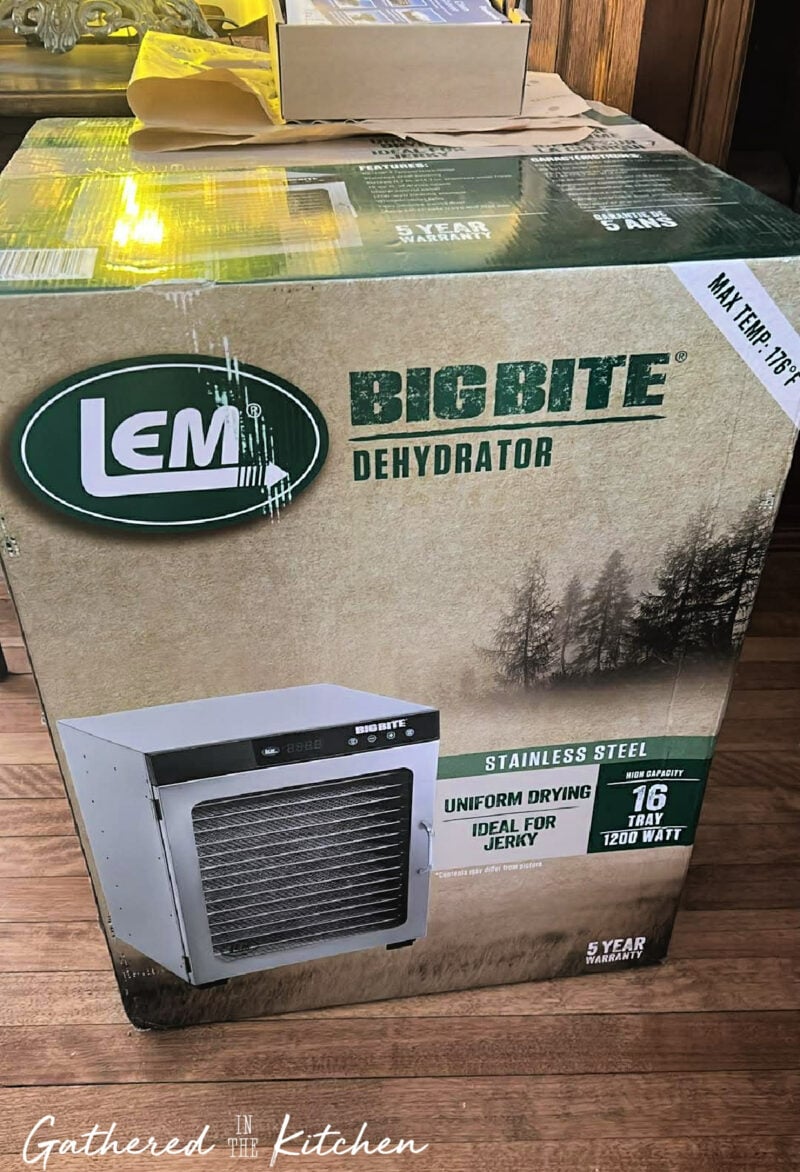 LEM Big Bite 16 Tray food dehydrator box showing stainless steel dehydrator, 16 tray capacity, and product details during unboxing in a home kitchen | Gathered In The Kitchen 