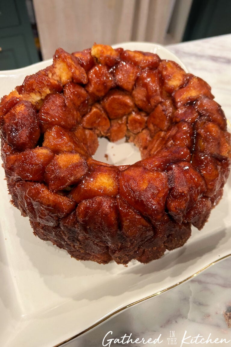 Gooey baked monkey bread made with canned biscuits and cinnamon sugar, served as a pull-apart breakfast bread. | Gathered In The Kitchen