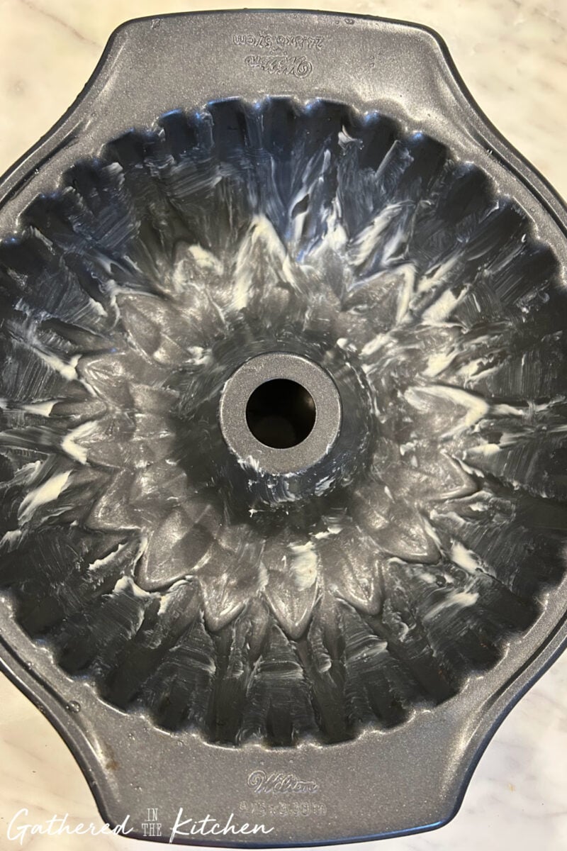 Bundt pan greased with vegetable shortening before adding monkey bread dough. | Gathered In The Kitchen 