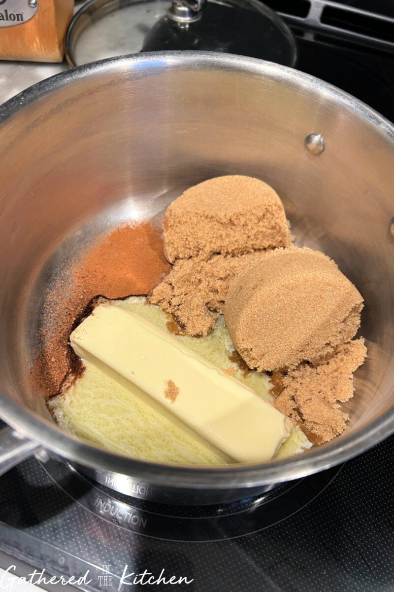 Butter, brown sugar, cinnamon, and nutmeg in saucepan for monkey bread glaze. | Gathered In The Kitchen 