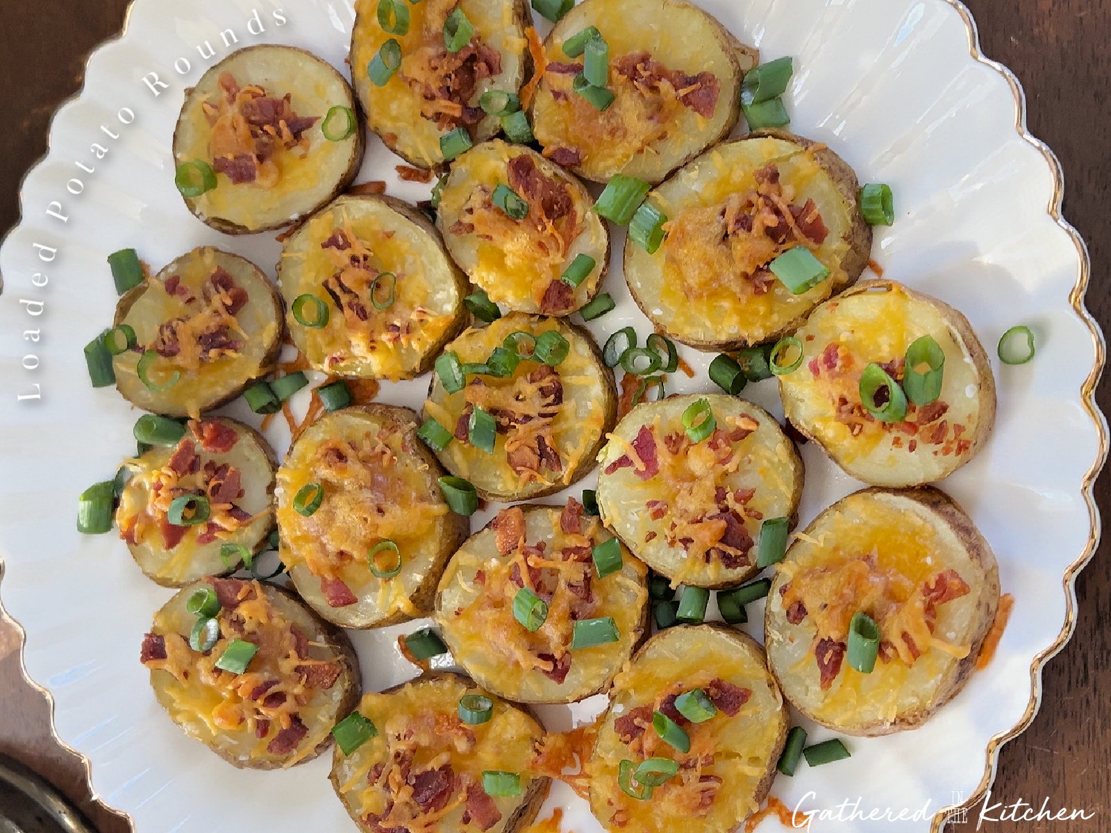 Loaded baked potato slices on a white plate with scalloped edges | Gathered In The Kitchen