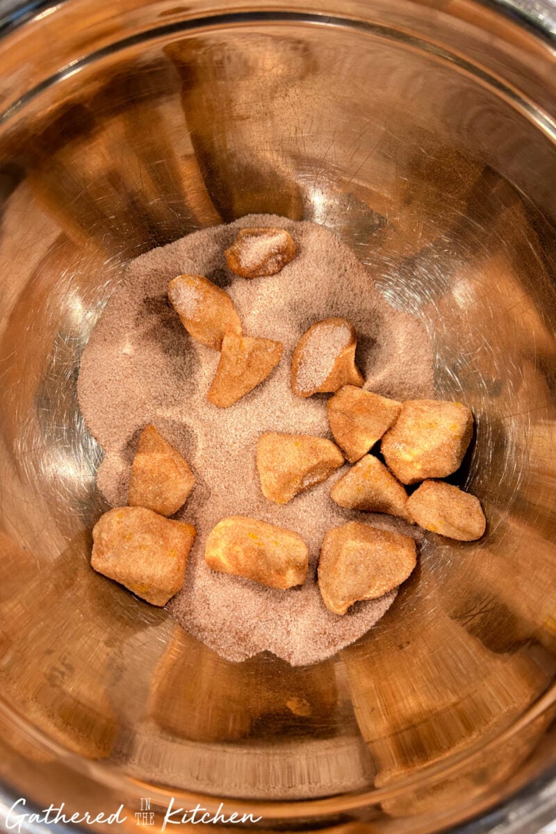 Biscuit dough pieces tossed in cinnamon sugar mixture for monkey bread. | Gathered In The Kitchen 