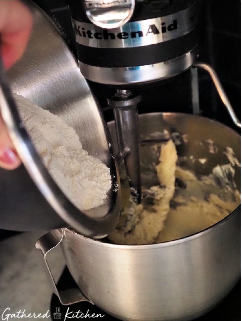 Adding dry ingredients to cookie dough in stand mixer | Adding flour to creamed butter, eggs, and vanilla when mixing cookie dough | Gathered In The Kitchen 